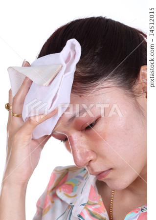 Woman holds an ice pack after nose job 14512015