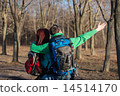 Couple of young tourists with backpacks standing back. 14514170