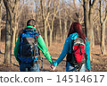 Couple of young tourists with backpacks standing back.  14514617