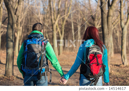 Couple of young tourists with backpacks standing back. Couple of young tourists with backpacks standing back. 14514617