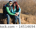 Couple  of young beautiful tourists with backpacks.  14514694