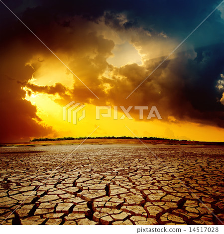 sunset over cracked desert 14517028