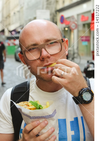 portrait of bald man eating at street 14517222
