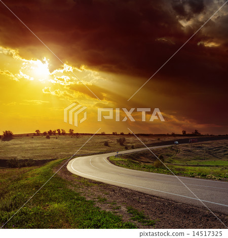 dramatic orange sunset over road 14517325