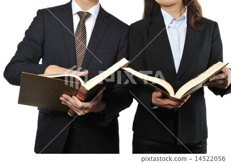 A male and female businessman reading a thick book A male and female businessman reading a thick book 14522056
