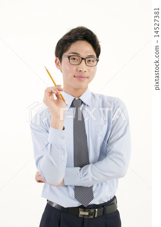 A businessman holding a pencil A businessman holding a pencil 14527381