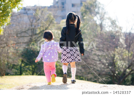 Two children and two sisters playing in the park Two children and two sisters playing in the park 14528337
