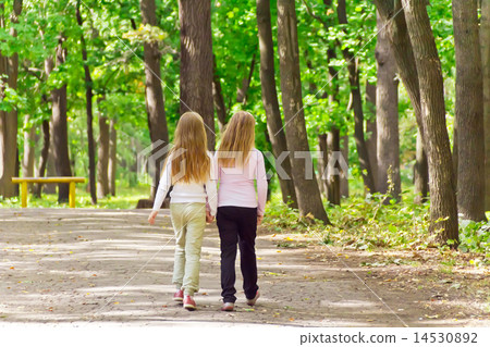 Cute two girls walking in park Cute two girls walking in park 14530892