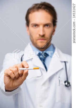 Doctor holding a sigarette Doctor holding a sigarette 14531427