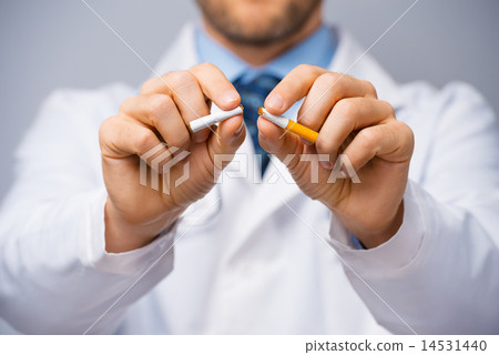 Doctor breaking a cigarette Doctor breaking a cigarette 14531440