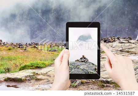 tourist taking photo of stone pyramid in Norway tourist taking photo of stone pyramid in Norway 14531587