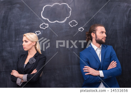 Male and female thinking together on th blackboard background Male and female thinking together on th blackboard background 14531656