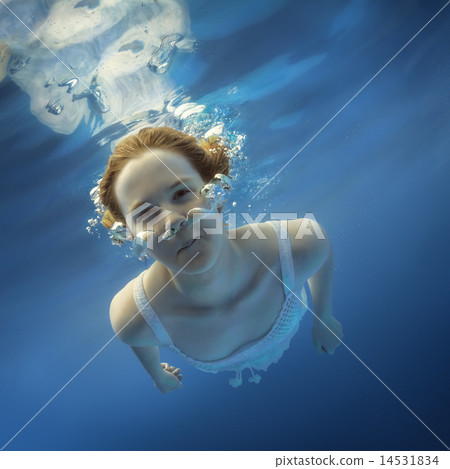 Girl blowing bubbles under water Girl blowing bubbles under water 14531834