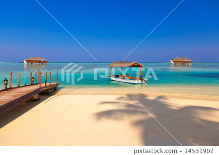 Boat and bungalow on Maldives island 14531902