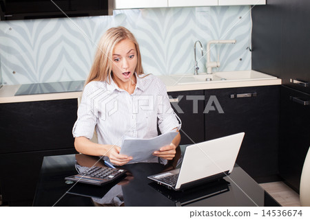 Surprised woman with surprise looks at documents Surprised woman with surprise looks at documents 14536674