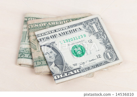 used US banknotes on wood table close up used US banknotes on wood table close up 14536810