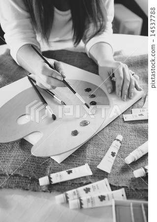 Monochrome photo of female artist working on new painting Monochrome photo of female artist working on new painting 14537788