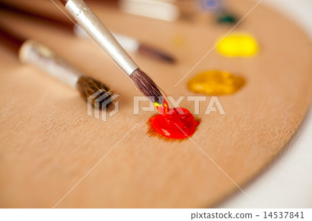 professional paintbrush dipped in red oil paint on palette professional paintbrush dipped in red oil paint on palette 14537841