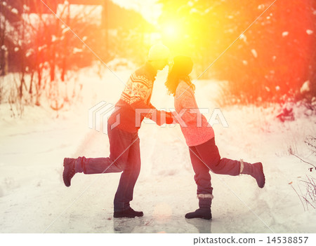 Young couple in love kissing outdoors in winter Young couple in love kissing outdoors in winter 14538857
