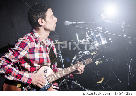 Man playing guitar during concert 14544255