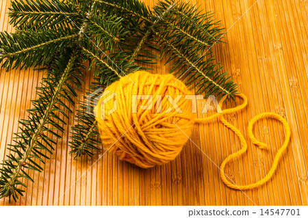 roll of yellow soft knitting yarn and yew branch roll of yellow soft knitting yarn and yew branch 14547701