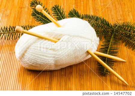 roll of white soft knitting yarn and yew branch roll of white soft knitting yarn and yew branch 14547702