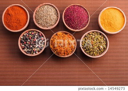assorted spices in a wooden bowl assorted spices in a wooden bowl 14549273