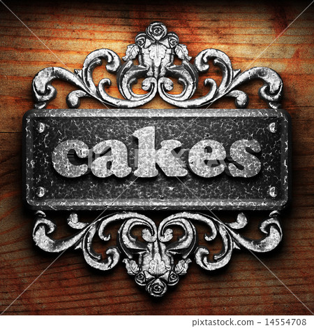 cakes word of iron on wooden background 14554708