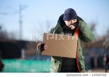 Homeless man holds blank cardboard for your own text Homeless man holds blank cardboard for your own text 14560708