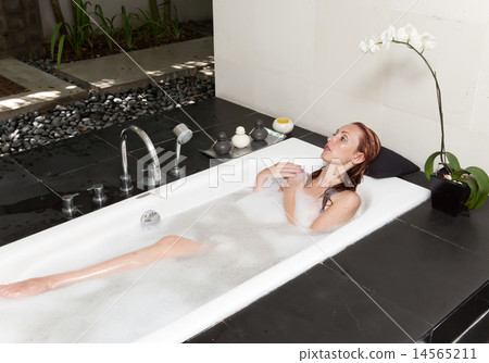 woman lays in soapsuds in bathing, full water woman lays in soapsuds in bathing, full water 14565211