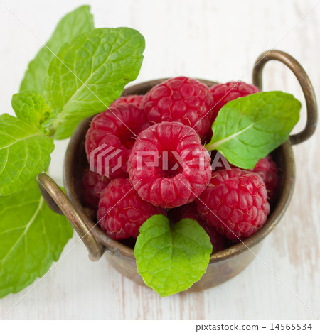 raspberries in old bowl with mint raspberries in old bowl with mint 14565534