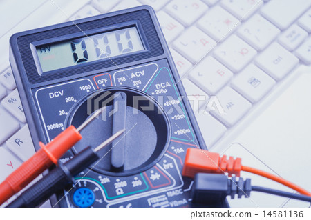 multimeter on the white laptop. close-up multimeter on the white laptop. close-up 14581136
