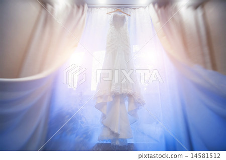 white Wedding dress hanging in a window. white Wedding dress hanging in a window. 14581512