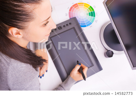 graphic designer working in office using tablet pen graphic designer working in office using tablet pen 14582773