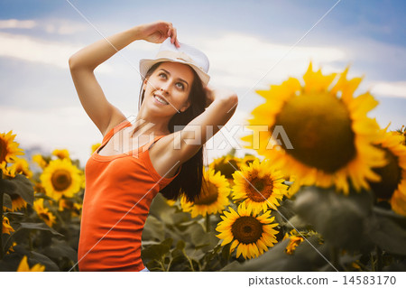 Sexy woman in a sunflower's field 14583170