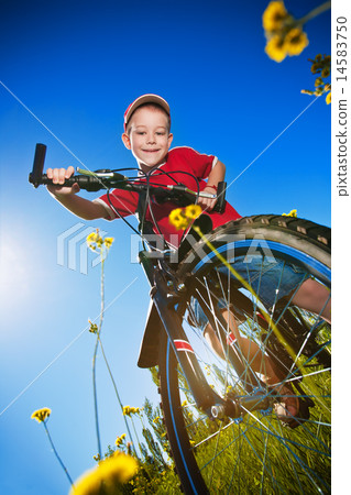 boy with bike standing against the blue sky boy with bike standing against the blue sky 14583750