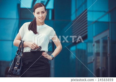 Business woman walking outside in city Business woman walking outside in city 14583859