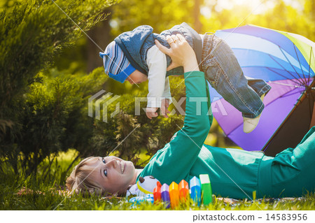 Happy mother and baby on the meadow 14583956