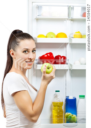 attractive girl near the open refrigerator attractive girl near the open refrigerator 14584017