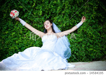 Bride is resting with outstretched arms Bride is resting with outstretched arms 14584195