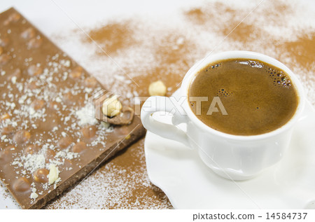 Cup of coffee and a chocolate in the background 14584737