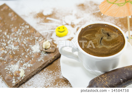 White cup of coffee and a chocolate 14584738