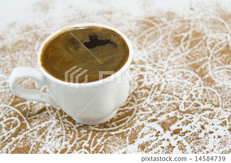 Cup of coffee on table covered with coffee grains 14584739