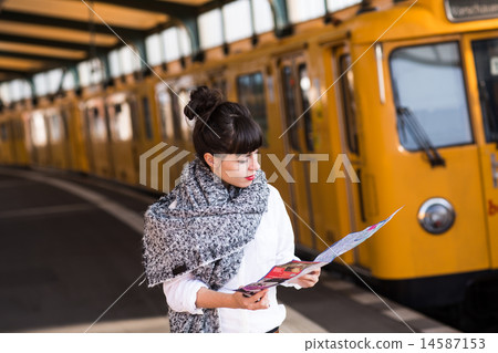 Young woman standing in public tramway 14587153