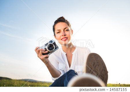 Beautiful girl sitting on the meadow Beautiful girl sitting on the meadow 14587155