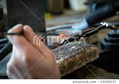 Craft jewelery making with flame torch. Craft jewelery making with flame torch. 14589235