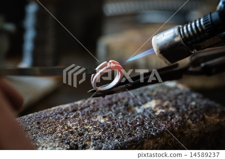 Craft jewelery making with flame torch. Craft jewelery making with flame torch. 14589237