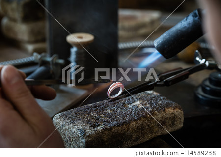 Craft jewelery making with flame torch. Craft jewelery making with flame torch. 14589238