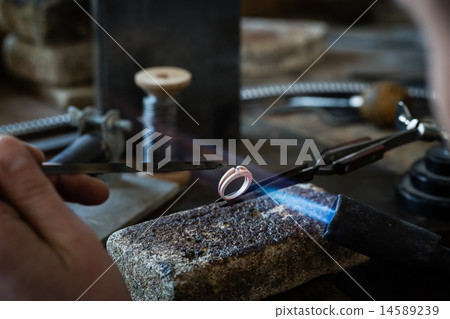 Craft jewelery making with flame torch. Craft jewelery making with flame torch. 14589239