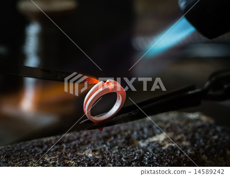 Craft jewelery making with flame torch. 14589242